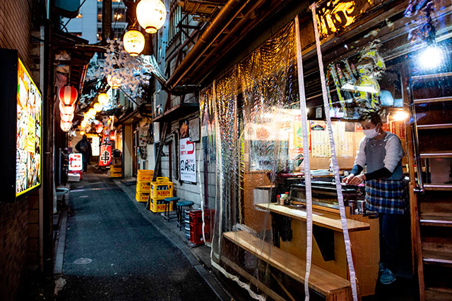 A restaurant staff prepares food at Omoide Yokocho alleyway in Shinjuku district in Tokyo on Thursday (AFP photo)