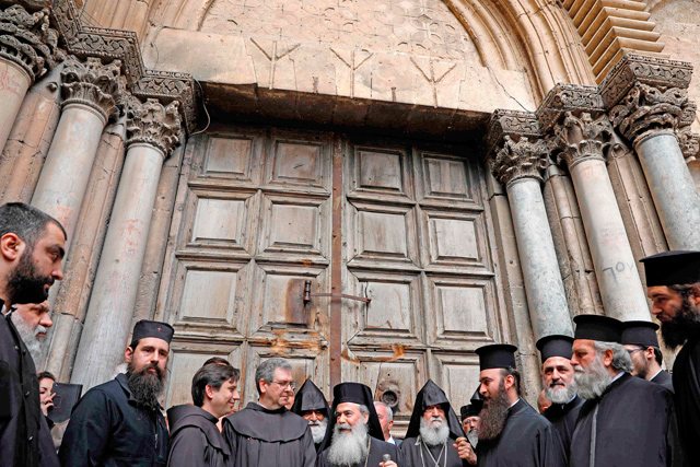 Greek Orthodox Patriarch of Jerusalem Theophilos III delivers a statement to the press as he stands next to the Custodian of the Holy Land Fr. Francesco Patton and Armenian Bishop Siwan (left), on Sunday, as they stand outside the closed doors of the Church of the Holy Sepulchre in Jerusalem's Old City (AFP photo)