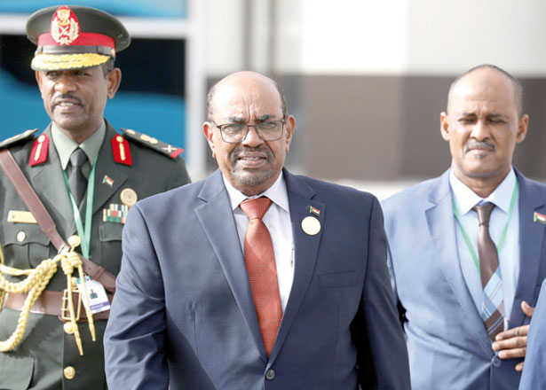 Sudanese President Omar Al Bashir walks with officials as he leaves an African Union summit in Nouakchott, Mauritania, on July 2 (Reuters file photo)