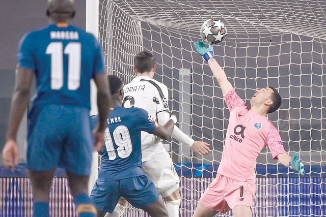 FC Porto's Argentinean goalkeeper Agustin Marchesin (right) concedes the second goal during the UEFA Champions League round of 16 second leg football match between Juventus Turin and FC Porto on Tuesday at the Juventus Stadium in Turin (AFP photo)