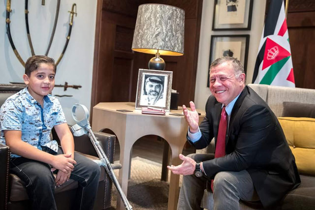 His Majesty King Abdullah receives Ibrahim Khawaldeh, a 10-year-old physically challenged boy, in Amman on Tuesday. His Majesty ordered immediate medical treatment of Khawaldeh (Photo courtesy of Royal Court)