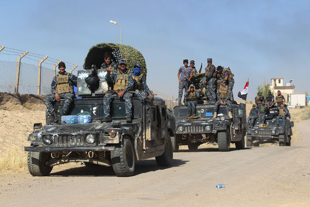 Iraqi government forces enter the Bai Hassan oilfield, west of the multi-ethnic northern Iraqi city of Kirkuk, on Tuesday (AFP photo)