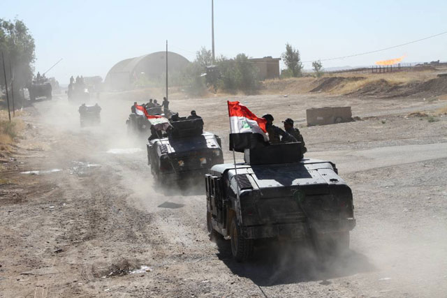 Armoured vehicles of Iraqi forces enter the Bai Hassan oil facility after peshmerga forces withdrew from the area in Kirkuk, Iraq, last week (Anadolu Agency photo)