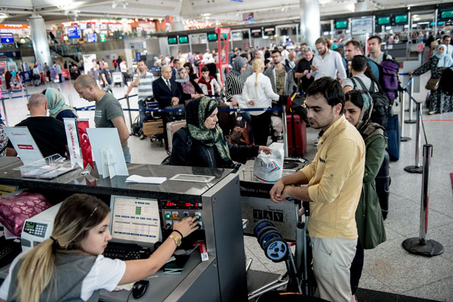 Passengers flying to Erbil wait to check-in for their flight at Ataturk International Airport in Istanbul on Thursday (AFP photo)