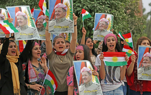 Iraqi Kurdish students of the Salahaddin University hold posters of Iraqi Kurdish leader Massud Barzani during a protest in his support in Erbil, the capital of autonomous Iraqi Kurdistan, on Monday (AFP photo)
