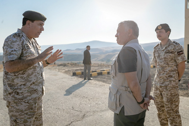 His Majesty King Abdullah, accompanied by HRH Crown Prince Hussein, is briefed on the historical, geographic and strategic importance of Baqura during a visit to the area on Monday (Photo courtesy of Royal Court)
