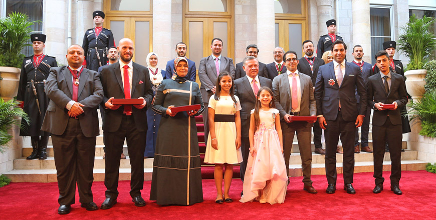 His Majesty King Abdullah poses for a group photo with honourees decorated during the celebrations held at Raghadan Palace on Thursday  (Photo courtesy of Royal Court)