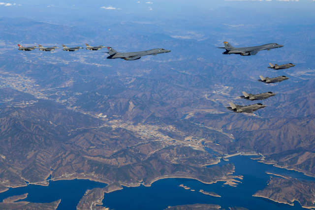 In this photo taken on Saturday and provided by the South Korean defence ministry, two US Air Force B-1B bombers (top centre), South Korean Air Force F-35 fighter jets (right) and US Air Force F-16 fighter jets (left) fly over the South Korean Peninsula during a joint air drill (AFP photo)
