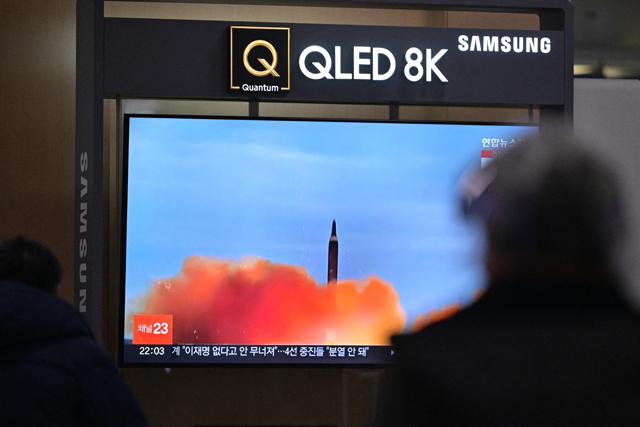 A man walks past a television showing a news broadcast with file footage of a North Korean missile test, at a railway station in Seoul, on Thursday (AFP photo)