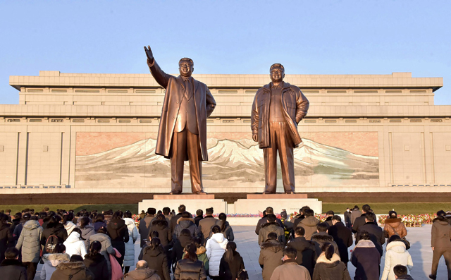 This photo taken on Friday and released from North Korea’s official Korean Central News Agency (KCNA) shows people bowing as they pay their respects before the statues of late North Korean leaders Kim Il -sung and Kim Jong-il, to mark tenth anniversary of the death of Kim Jong- il, the father of current leader Kim Jong-un, at the Mansu Hill in Pyongyang (AFP photo)