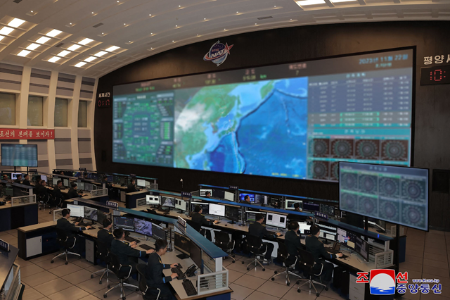 This photo taken and released on Wednesday from North Korea's official Korean Central News Agency (KCNA) shows a view (screens digitally blurred as received from source) of the Pyongyang General Control Centre of the Korean National Aerospace Technology Directorate (AFP photo)