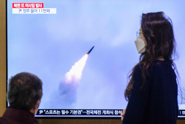 People watch a television screen showing a news broadcast with file footage of a North Korean missile test, at a railway station in Seoul, on Sunday (AFP photo)