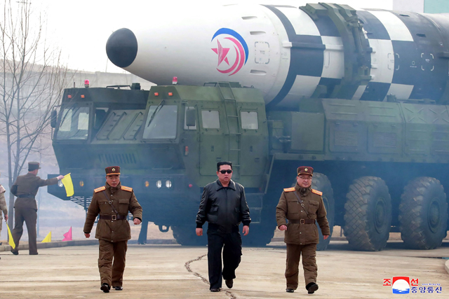 This file photo taken on March 24 and released from North Korea's official Korean Central News Agency (KCNA) on March 25 shows North Korean leader Kim Jong -un (centre) walking near what a state media report says was a new type of inter-continental ballistic missile (ICBM) before its test launch at an undisclosed location in North Korea (AFP photo)