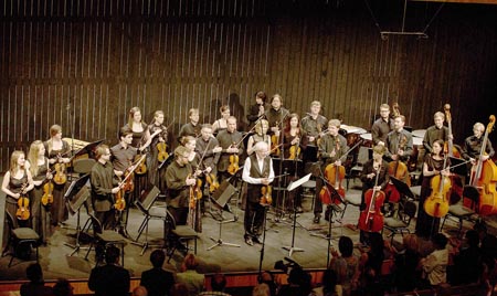 Kremerata Baltica Chamber Orchestra acknowledge founder and violinist Gidon Kremer (middle) in undated photo (Photo courtesy of Friends of Jordan Festivals)