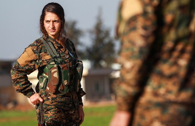 A fighter from the Kurdish women’s protection units attends a funeral of an Arab fighter of Syrian Democratic Forces in the town Tal Tamr,Syria, on December 21 (AFP photo)