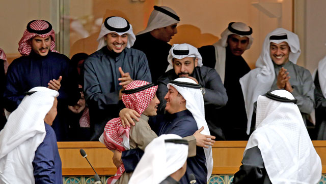 MPs congratulate Kuwaiti parliament speaker Marzouk Al Ghanem (centre) after his election during the opening session of the new parliament in Kuwait City on Sunday (AFP photo)