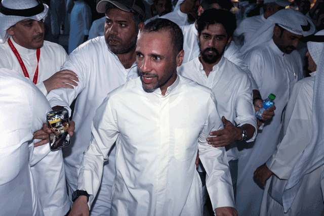 Kuwaiti candidate and former parliament speaker Marzouq Al Ghanim celebrates with his supporters following the announcement of his victory in legislative elections, in Kuwait city, on early Wednesday  (AFP photo)