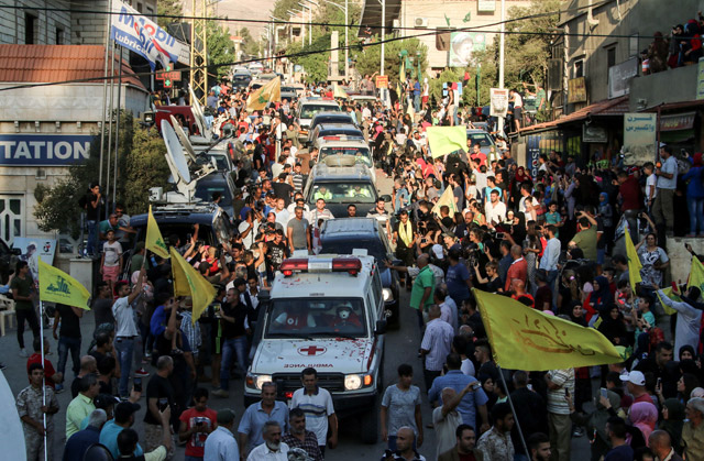 A photo taken on Sunday shows an ambulance convoy of the Lebanese Shiite Hizbollah movement entering the village of Al Labweh, part of the Baalbek-Hermel Governorate, while returning the bodies of fighters killed in week-long clashes in the Jurud Arsal border region, as part of a ceasefire deal, amid commemorations of the fighters by locals (AFP photo)