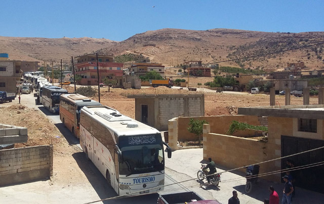 A picture taken on Monday shows a convoy carrying Syrian militants and their families, who have been in eastern Lebanon since the beginning of the Syrian war, entering the Lebanese Wadi Al Hamid area, in the Jurud Arsal border region, to be transported to Syria’s northwestern province of Idlib, as part of the second phase of a ceasefire deal  (AFP photo)