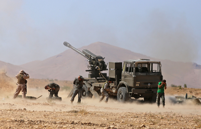 Syrian pro-government forces fire towards extremist positions, in the western Qalamoun, on Wednesday, during an offensive against Daesh extremists (AFP photo)