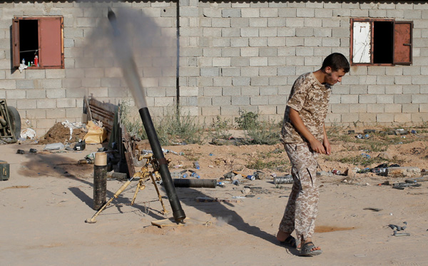 A fighter of Libyan forces allied with the UN-backed government fires a 81mm mortar round in Sirte, Libya, on Tuesday (Reuters phot)