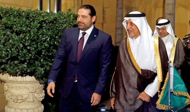 Lebanese Prime Minister-designate Saad Al Hariri (left) walks with Saudi Arabia’s Prince Khaled Al Faisal in Beirut, Lebanon, on Monday (Reuters photo)