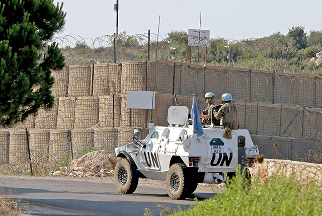 A United Nations Interim Force in Lebanon (UNIFIL) convoy drives past one of their outposts manned by Italian peacekeepers, during a patrol on Thursday on the road between the southern Lebanese towns of Naqura and Shamaa near the border with Israel (AFP photo)