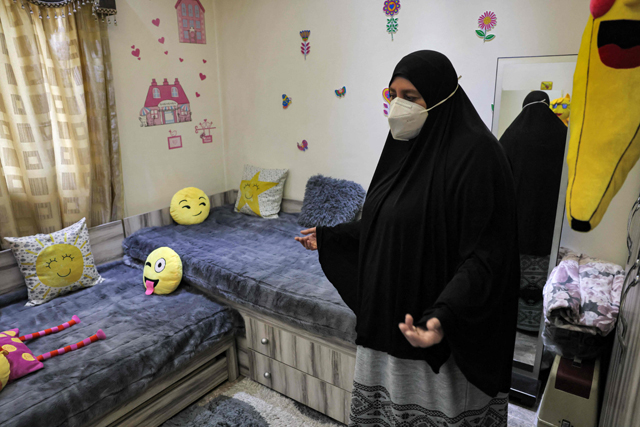 Umm Mohammed Iali, a 50-year-old Lebanese woman whose two sons died fighting for the Daeshe group in Syria and whose granddaughters remain in the northeast Syrian camp of Al Hol, gives a tour of the bedroom she prepared for her granddaughters Mariam and Maria at her apartment in Lebanon’s northern city of Tripoli, on February 10 (AFP photo)