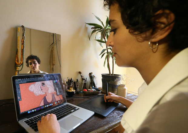 Lebanese artist Christina Atik works on her illustration, at her apartment, in Beirut, Lebanon, on Tuesday (Reuters  photo)