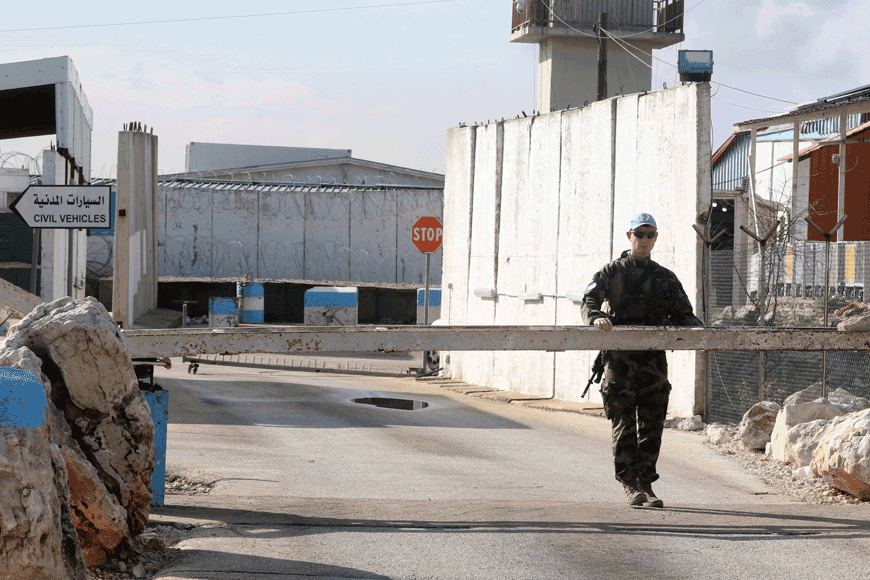 An Irish soldier from the United Nations Interim Force in Lebanon, stands guard at the entrance of his base in the southern Lebanese village of Al Tiri, on Friday (AFP photo)
