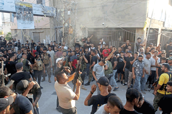 Fighters fire into the air during the funeral of two Fateh commanders at the Rashidieh Palestinian refugee camp in the southern Lebanese port city of Tyre on Monday (AFP photo)