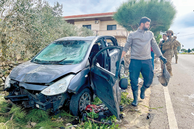 Lebanese army soldiers secure the area around a vehicle targeted in an Israeli drone attack in the town of Bint Jbeil near the border with Israel on Monday (AFP photo)