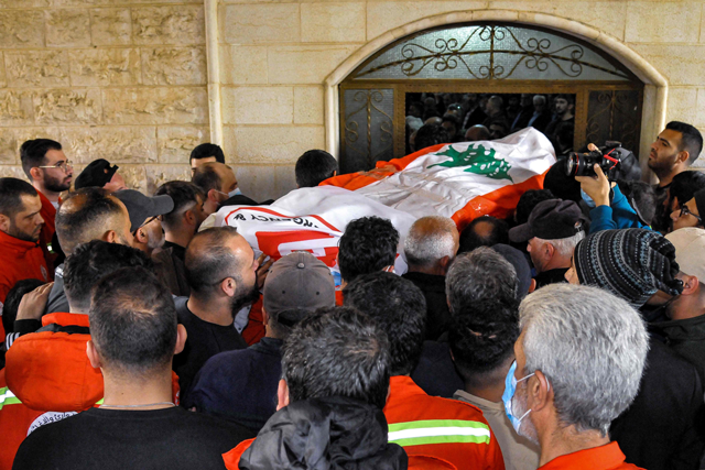 People and members of the Lebanese NGO Emergency and Relief Corps carry the body of one of the victims killed during overnight Israeli bombardment, during the funeral in the village of Habariyeh in southern Lebanon, on Wednesday (AFP photo)