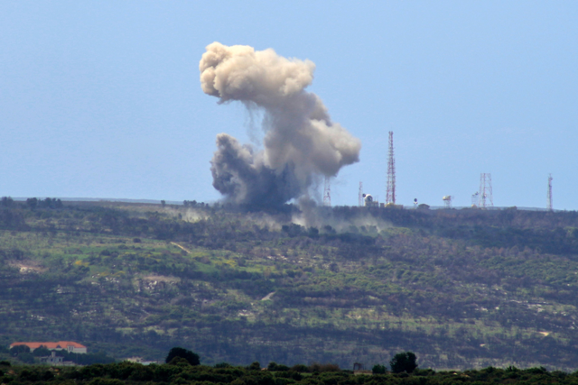 A photo taken from the southern Lebanese village of Alma Al Shaab shows smoke rising from an Israeli outpost after a rocket attack by Lebanon’s Hizbollah movement fighters on Saturday (AFP photo)