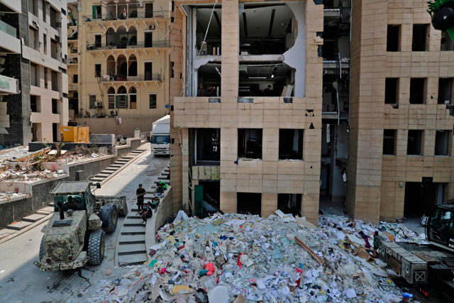 A bulldozer removes the debris of a destroyed neighbourhood facing the port of Beirut following last week's cataclysmic explosion on Wednesday (AFP photo)