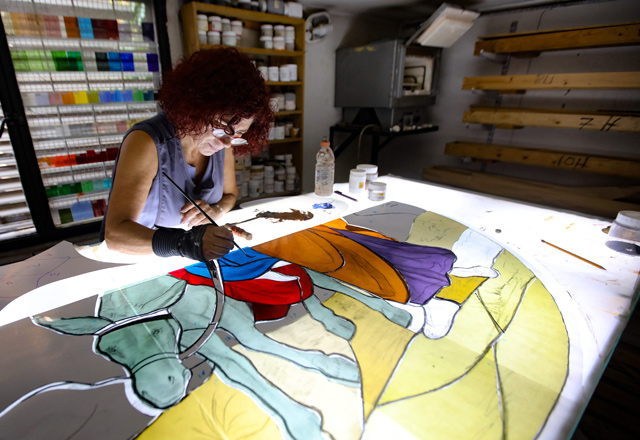 Lebanese stained glass artist Maya Husseini, 60, works on a piece for a cathedral under construction in Jordan, her main project before the Beirut port blast, in her basement workshop on the outskirts of the capital Beirut, on September 18 (AFP photo)