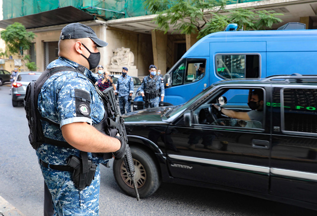 Lebanese policemen check cars at a checkpoint in the Sanayeh district of the Lebanese capital Beirut a day after the country went into lockdown, in a bid to stem the spread of the novel coronavirus, on Saturday (AFP photo)