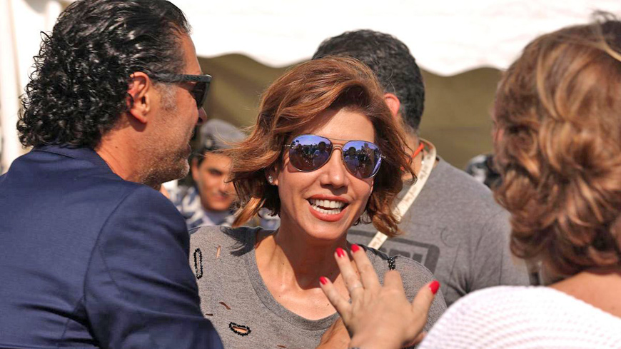 Lebanese singer Ragheb Alameh (left) welcomes Lebanese TV host Paula Yacoubian (centre) during a karting race organised by Lebanese celebrities to mark the beginning of the Beirut Cultural Festival at Beirut’s water front on May 20, 2016 (AFP photo)