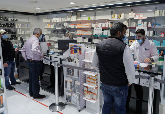 Customers buy medicine at a pharmacy in the Lebanese capital Beirut, on February 2 (AFP photo)