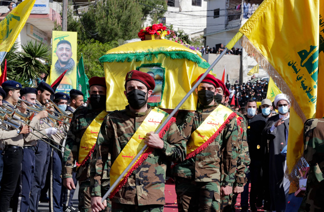 Members of the Iran-backed Hizbollah movement, carry the coffin of Mohamad Kassem Tahan, a fellow member killed a day earlier by Israeli shelling on the frontier with Lebanon during a protest against the latest assault on the Gaza Strip, at his funeral in the southern Lebanese village of Adloun, on Saturday (AFP photo)