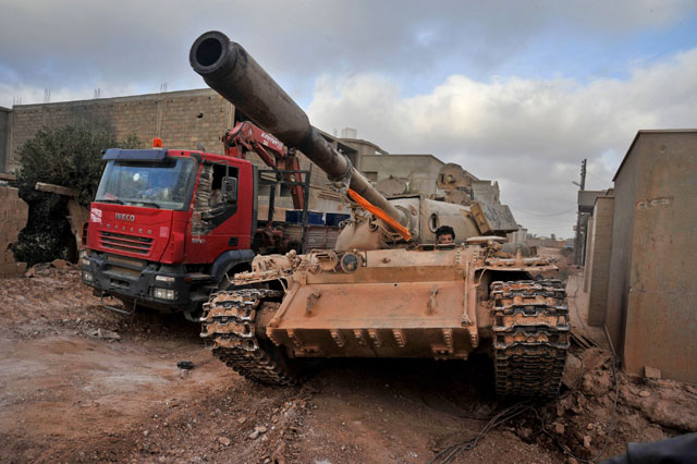 In this March 7 file photo, a man loyal to the Libyan armed forces sits in a tank during clashes with the Daesh terror group, west of Benghazi (AP photo)