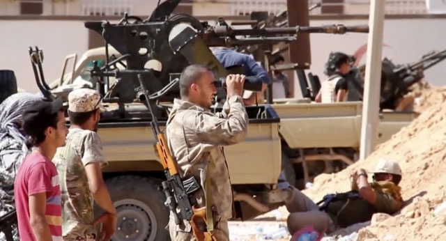 This image made from an Associated Press video on Tuesday shows an armed Misrata fighter loyal to the unity government on the main street of Sirte  (AP photo)