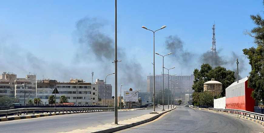 Smoke billows as rival Libyan groups exchange fire in the capital Tripoli on Saturday (AFP photo)