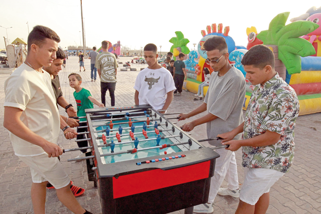 Youth play table football along the waterfront promenade in Libya’s eastern second city of Benghazi, on Wednesday (AFP photo)
