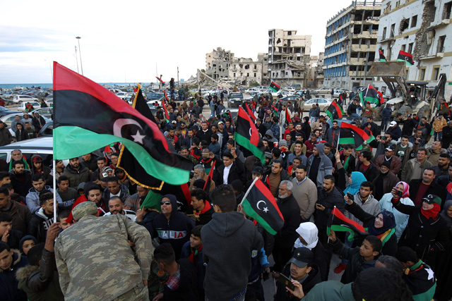 Libyans gather to mark the eighth anniversary of the uprising in Libya's second city of Benghazi, on Sunday (AFP photo)