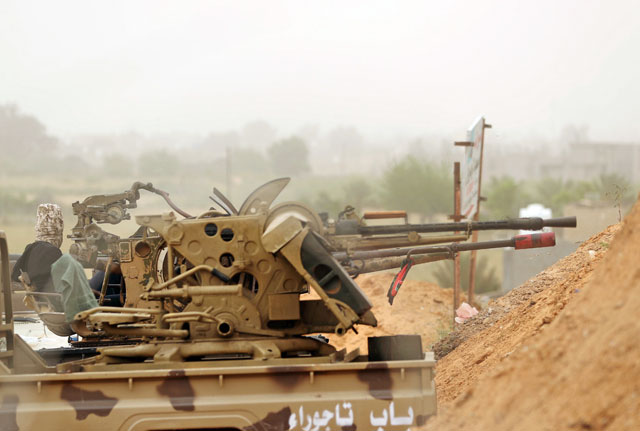 Members of the internationally-recognised Libyan government forces take position during the fighting with the eastern forces in Ain Zara, in Tripoli, Libya, on Sunday  (Reuters photo)