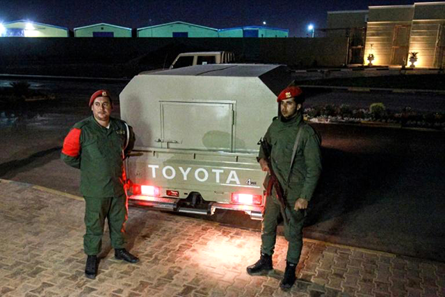 Military police loyal to strongman Khalifa Haftar stand guard earlier this month outside a vehicle allegedly containing arrested Syrian mercenaries (AFP photo)