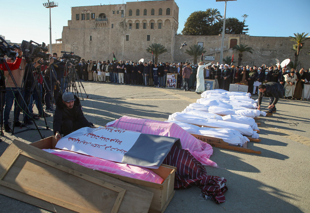 Mourners gather to pay respects around bodies of victims found in mass graves in a once militia-controlled town, for a prayers ceremony before burial in Martyrs' Square of Libya's capital Tripoli, on Friday (AFP photo)