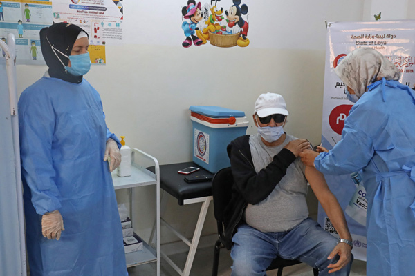 Libyan medics administer the AstraZeneca COVID-19 vaccine to elderly members of the community with the start of the inoculation drive in the capital Tripoli, on Saturday (AFP photo)