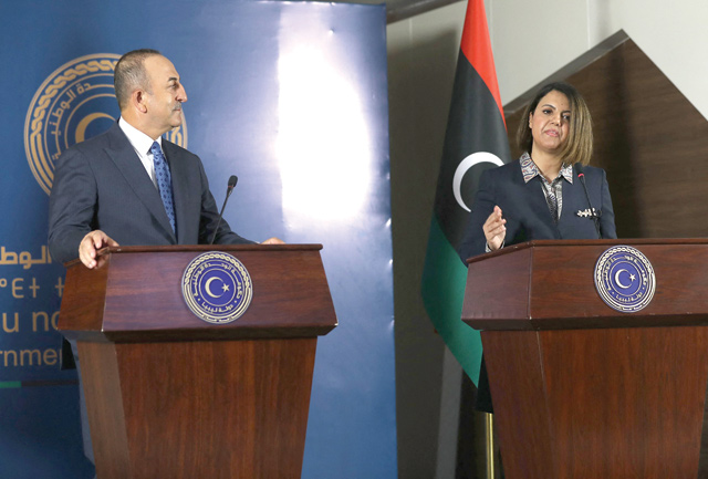 Libya's Foreign Minister Najla Al Mangoush (right) and Turkish counterpart Mevlut Cavusoglu give a joint press conference in the capital Tripoli, on Monday (AFP photo)
